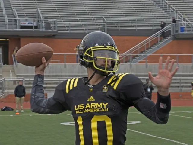 In this picture we can observe a rugby player wearing black color dress and a helmet on his head....