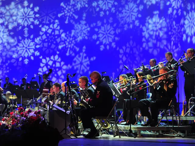 The image shows a group of people playing musical instruments on a stage, surrounded by mics with...