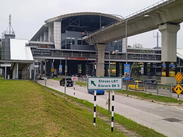 The image shows a highway with cars driving down it, a bridge in the background, street lights...