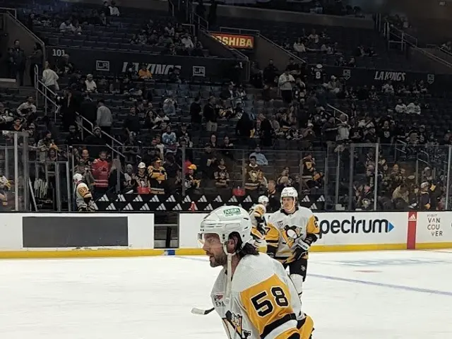 The image shows a hockey player on the ice with a stick in hand, wearing a helmet, gloves, and...