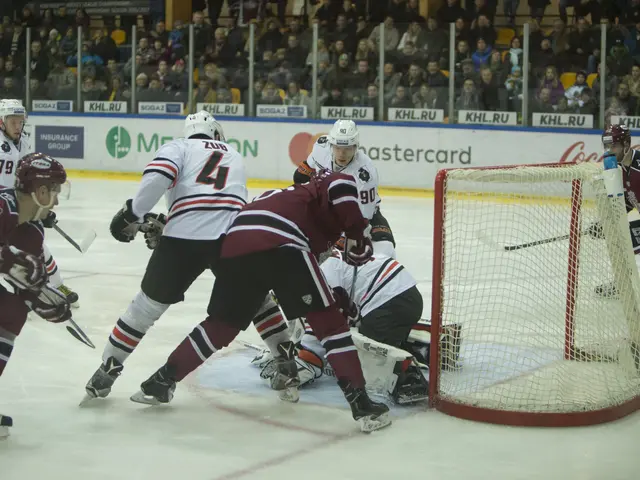 The image shows a group of people playing a game of hockey on an ice rink. They are wearing sports...