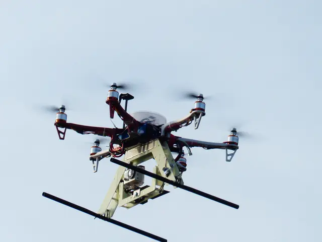 The image shows a white and red drone flying through the air with its landing gear down, against a...