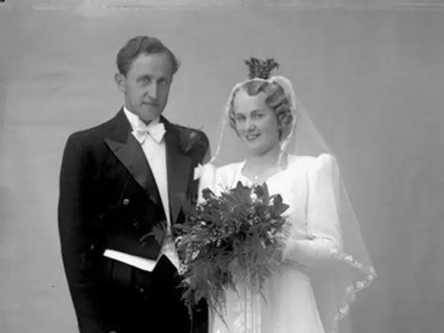 The image shows an old black and white photo of a bride and groom with their two children. The...