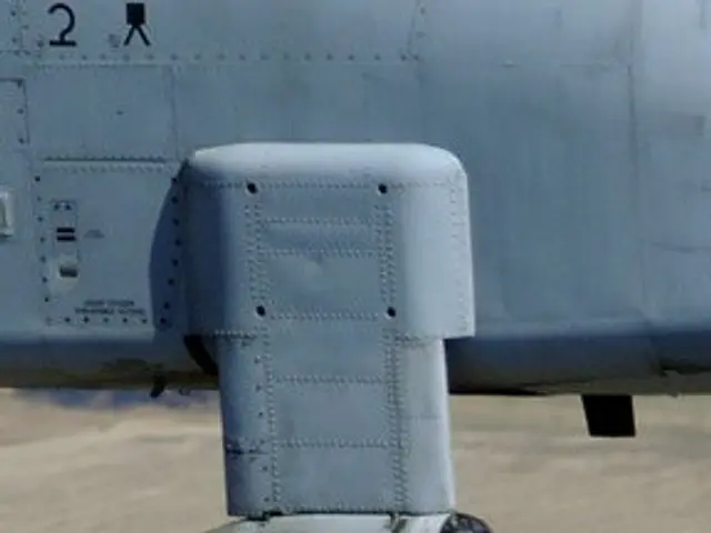The image shows a close up of a military plane with a missile attached to it, flying through the...