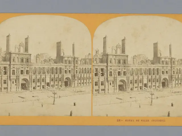 The image shows an old photo of a large building with a lot of windows, surrounded by a few people...