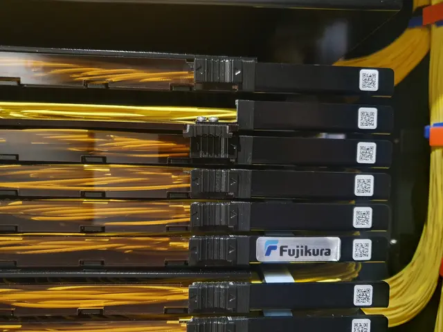 The image shows a close up of a rack of servers in a data center, with electronic devices and wires...