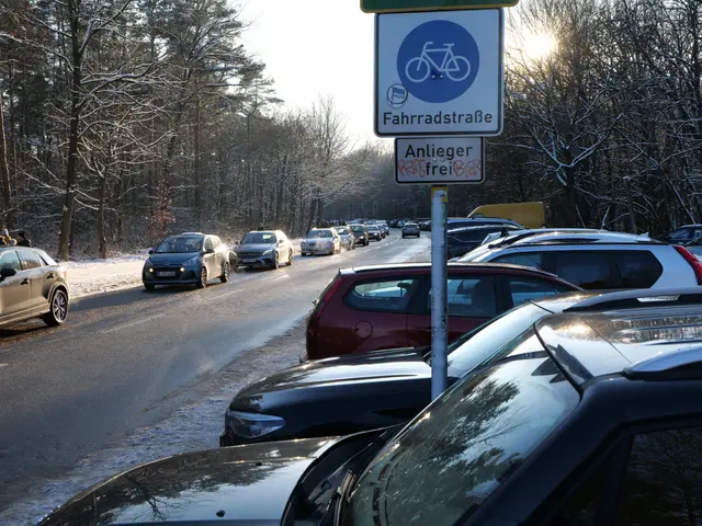The image shows a traffic jam on a snowy road with cars parked on the side. There is a pole with a...