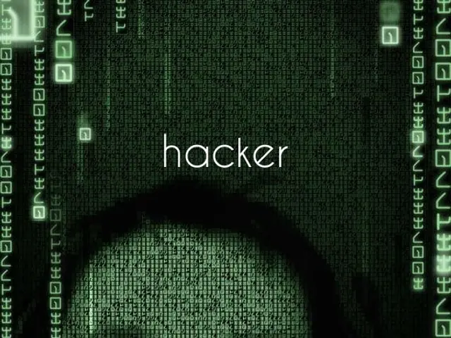 The image shows a hacker's face on a computer screen with the word "hacker" written on it,...
