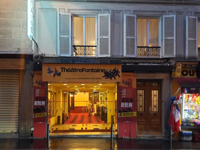 The image shows the Theatre Fontaine in Paris, France. It is a building with windows and doors, a...