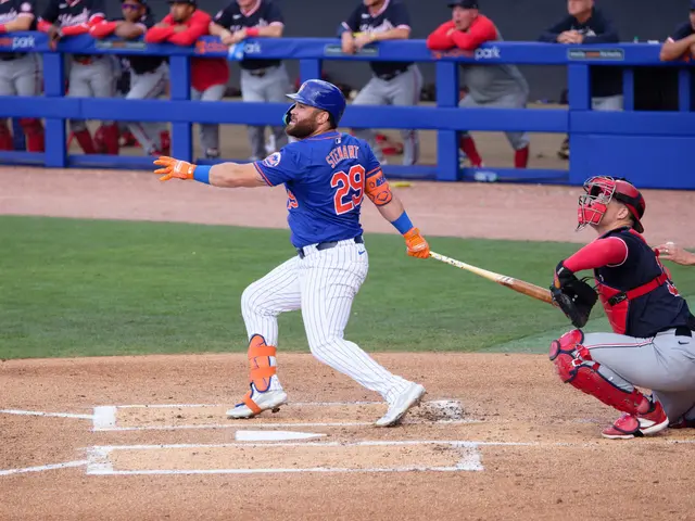 The image shows a baseball player swinging a bat on top of a field. The player is wearing a blue...