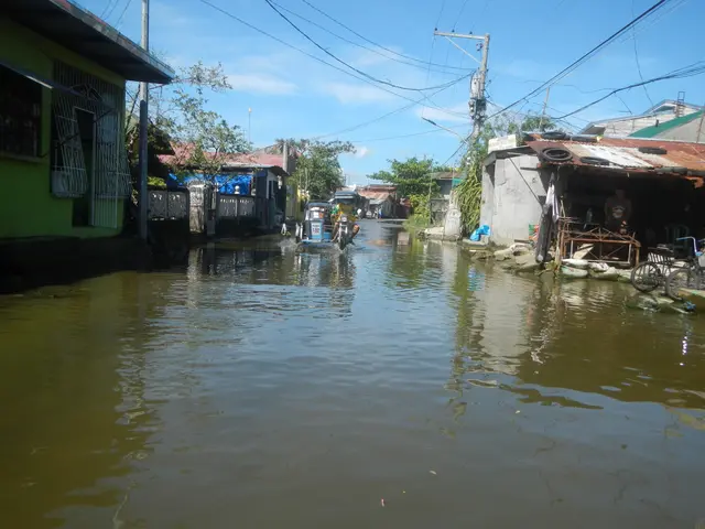 The image shows a flooded street in Manila, Philippines, with vehicles on the water, buildings,...