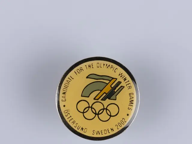 The image shows a white surface with a badge featuring the Olympic Winter Games logo and text. The...