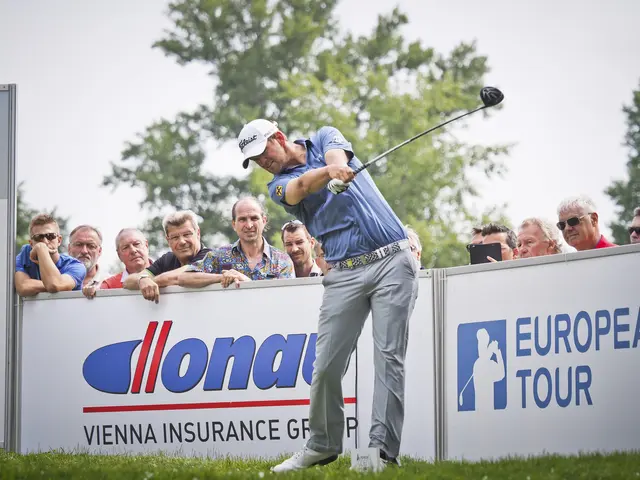 The image shows a man wearing a cap and swinging a golf club on top of a lush green field. In the...