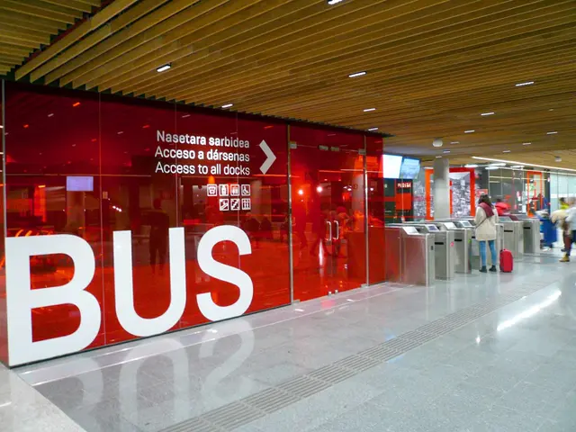 The image shows a group of people walking through an airport terminal with a bus sign on the wall....