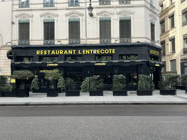 The image shows a restaurant called L'Entrecote in Paris, France. It is a building with windows, a...
