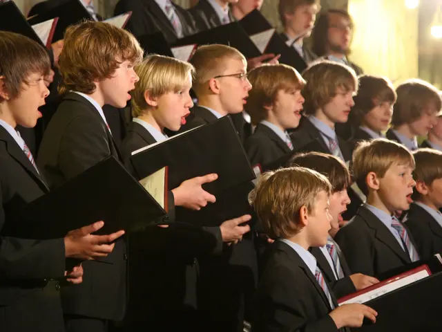 The image shows a group of young boys in suits and ties standing in front of a choir, each holding...