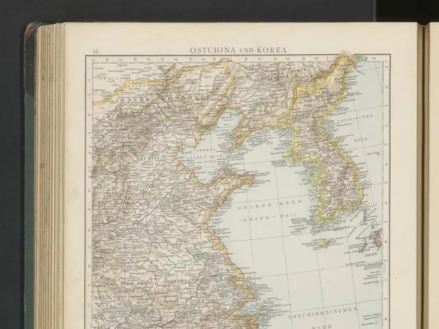 The image shows an open book with a map of South Korea on it, set against a black background. The...