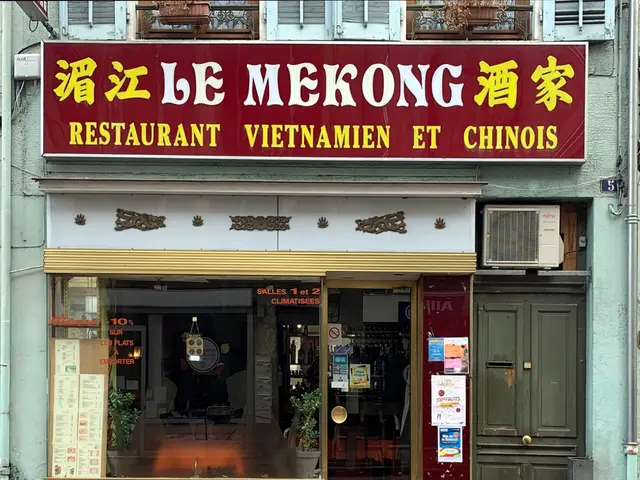 The image shows a building with windows, a door, a signboard with some text on it, some papers...