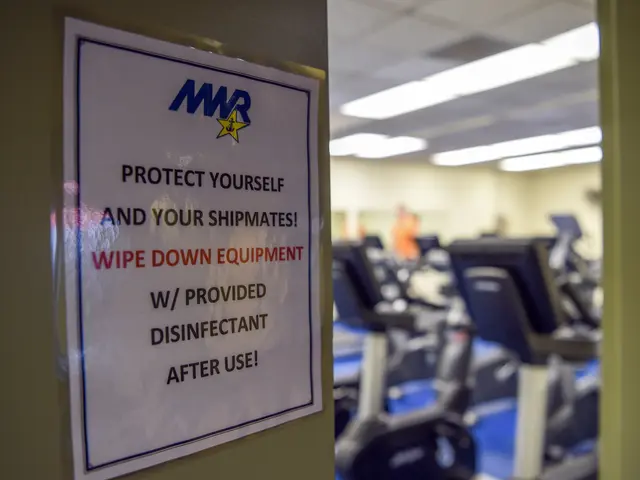 The image shows a sign on the door of a gym that reads "Protect Yourself and Your Shipmates" with a...