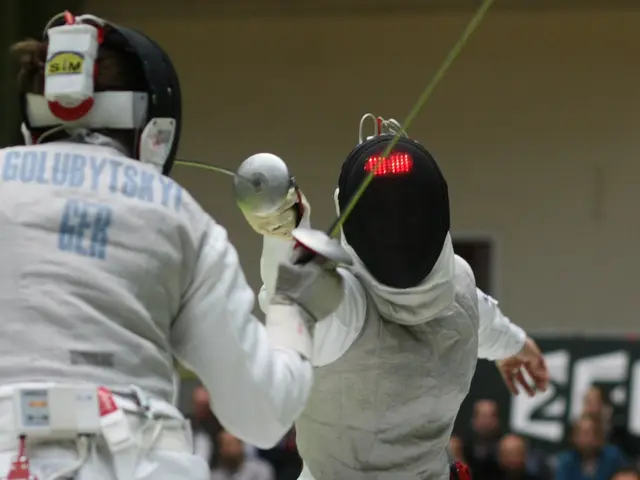 The image shows two fencers in action at the Olympics, both wearing white fencing costumes and...
