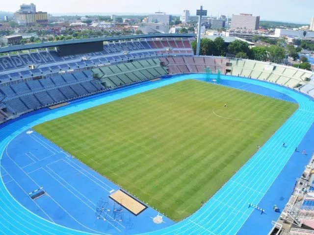 The image shows an aerial view of the Olympic Stadium in Kiev, Ukraine. We can see the stadium with...