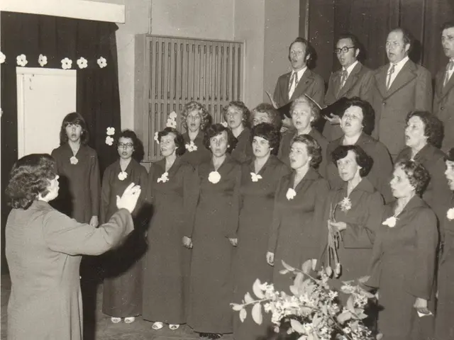 The image shows a group of people standing in front of a choir, with a woman in the center holding...