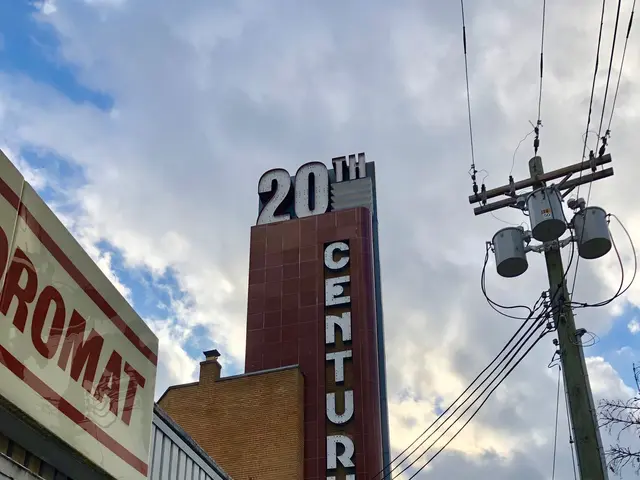 The image shows the 20th Century Theatre in Detroit, Michigan. It is a building with glass walls...