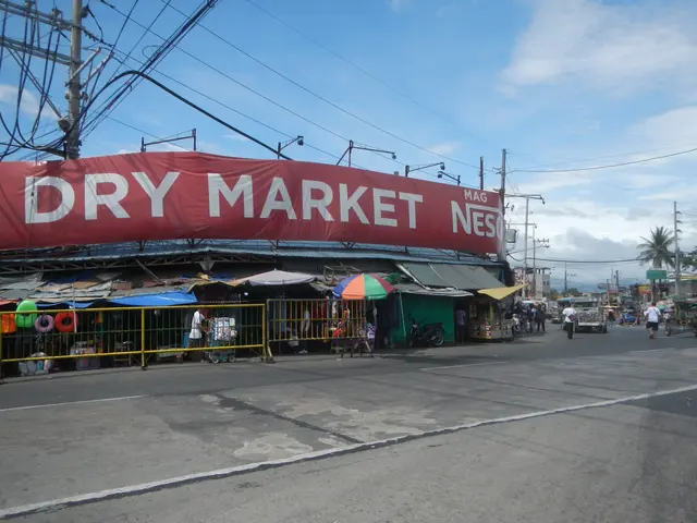 The image shows a bustling dry market in the Philippines, with a group of people standing on the...