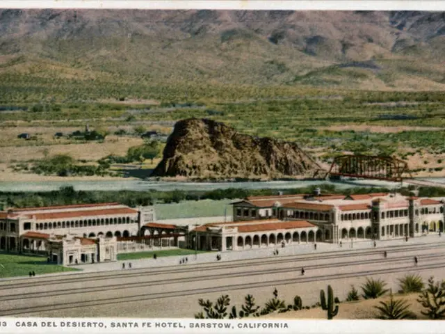 The image shows an old postcard of the Casa del Desierto, Santa Fe Hotel in Barstow, California. It...