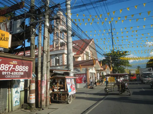 The image shows a bustling street in Manila, Philippines, with vehicles on the road, people walking...
