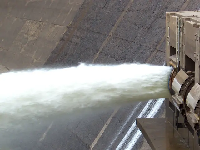 The image shows a hydroelectric dam with water flowing out of it, creating a large amount of water....