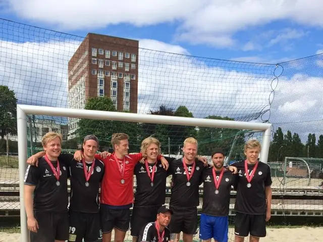 The image shows a group of men standing next to each other on top of a sandy beach, wearing medals...
