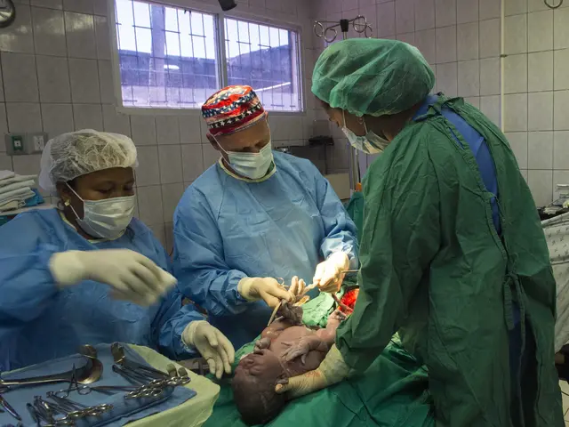 The image shows a group of surgeons wearing masks, caps, and gloves performing surgery on a baby...