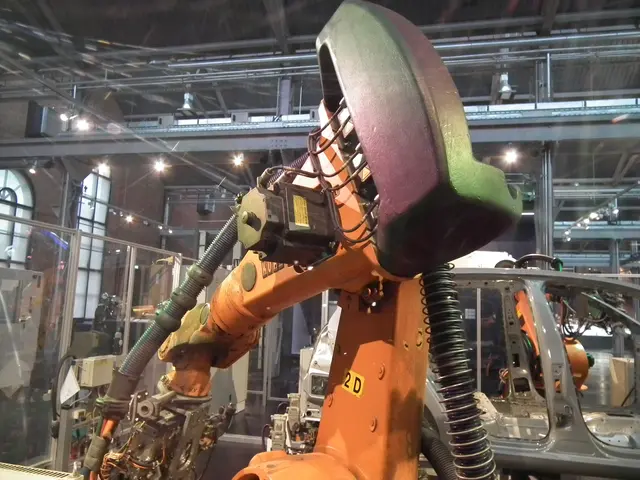 The image shows a robotic arm working on a car in a factory, surrounded by metal rods, lights, and...