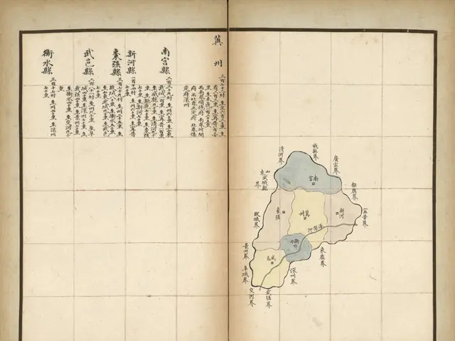 The image shows an open book with Chinese writing on it and a map of a city. The map is detailed...