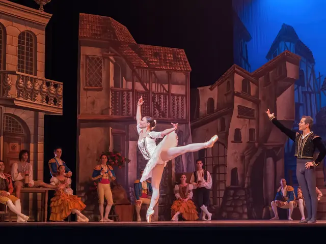 The image shows a man and a woman dancing on a stage in front of a crowd of people, some of whom...