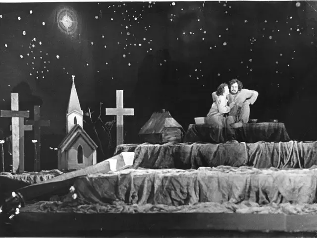 The image shows a black and white scene of a man and woman sitting on top of a bed, embracing each...