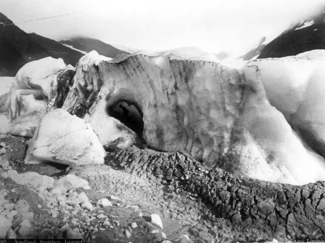 The image shows a black and white photo of a large glacier with a hole in the middle, surrounded by...