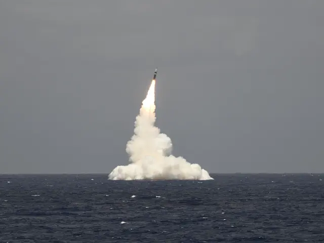 The image shows a missile being launched from a ship in the ocean, with fire and smoke billowing...