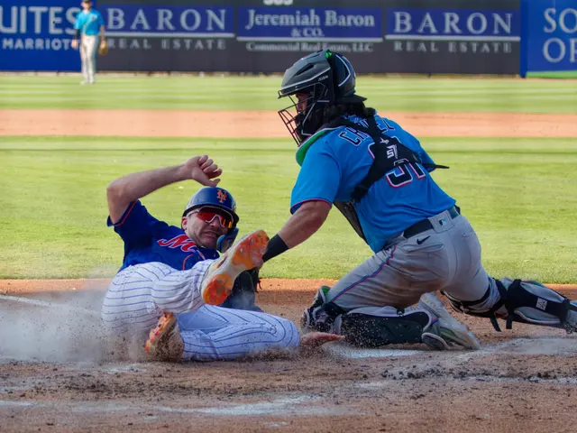 The image shows a baseball player sliding into home plate during a game. The player is wearing a...