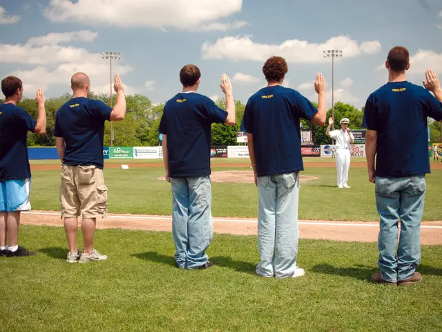 The image shows a group of men standing on top of a baseball field, clapping their hands in...