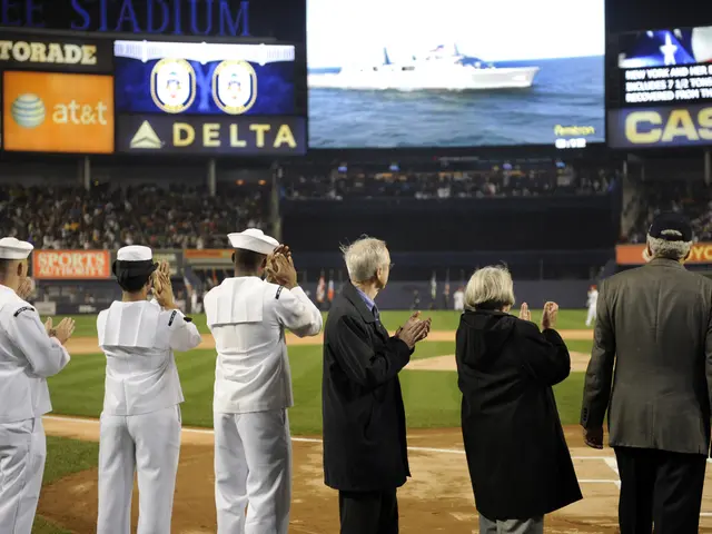 The image shows a group of people standing on top of a baseball field, clapping their hands in...