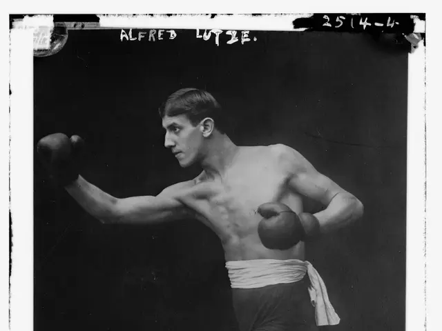 The image shows a black and white photo of a man wearing boxing gloves and shorts, with text at the...
