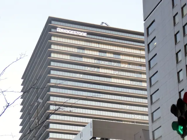 The image shows a tall skyscraper in the middle of a city street, surrounded by other buildings,...