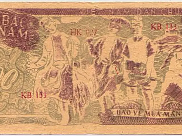 The image shows an old banknote from Vietnam with a picture of a group of people on it. The note is...
