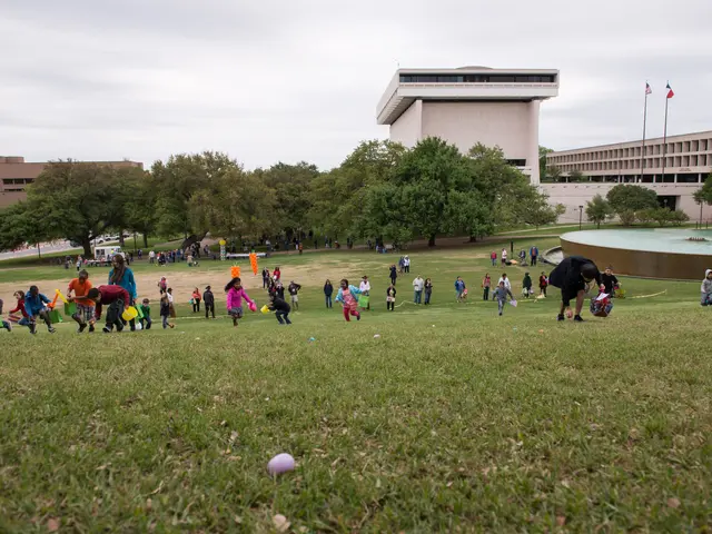 The image shows a group of people playing with Easter eggs in a grassy field surrounded by trees...