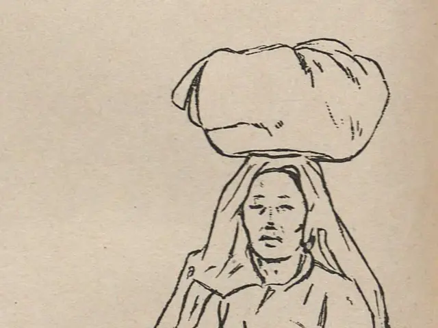 The image shows a woman walking with a stick in one hand and a large bag on her head. She has a...