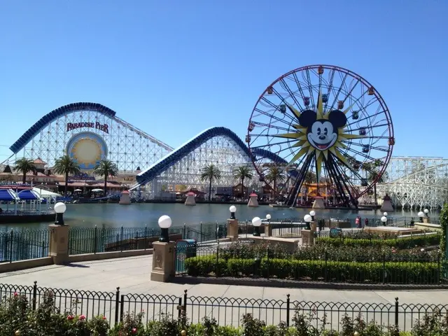 The image shows Disneyland's California Adventure, with its iconic Ferris wheel and roller coaster,...