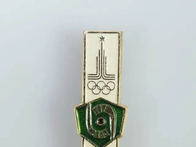 The image shows a white surface with a badge featuring the logo of the 1980 Olympic Games in...