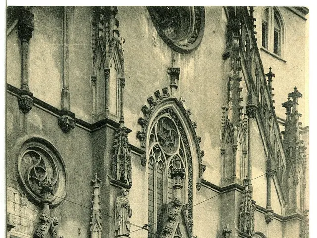 The image shows an old black and white photo of a building with arches and sculptures adorning its...